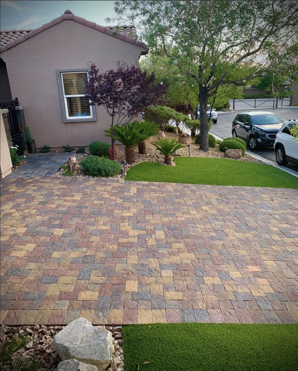 Front yard paver driveway with turf border