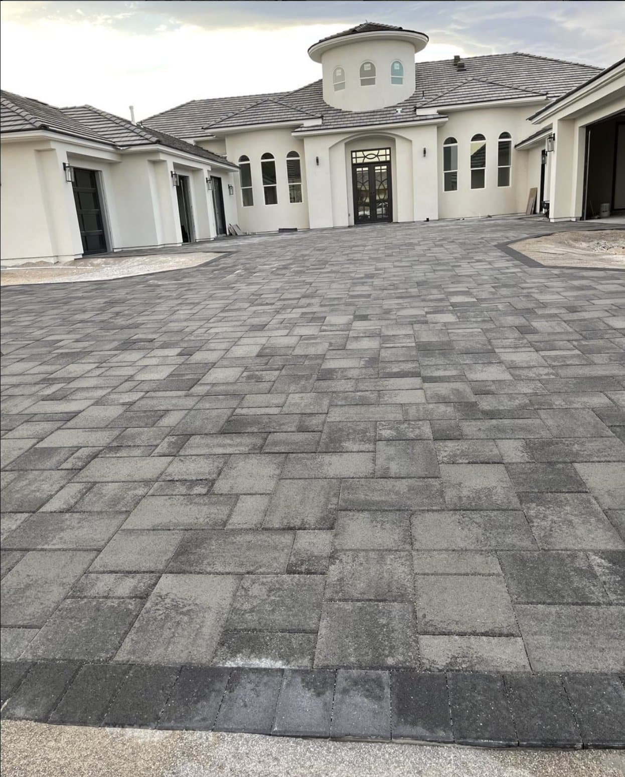 Large paver courtyard and driveway