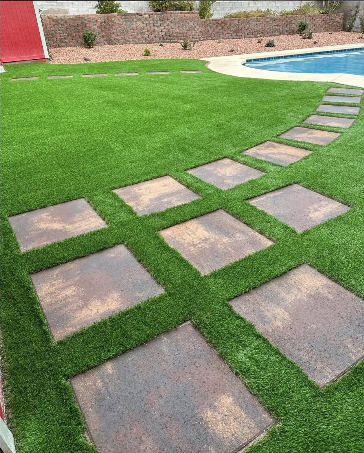 Pool deck with turf-and-paver grid pathway
